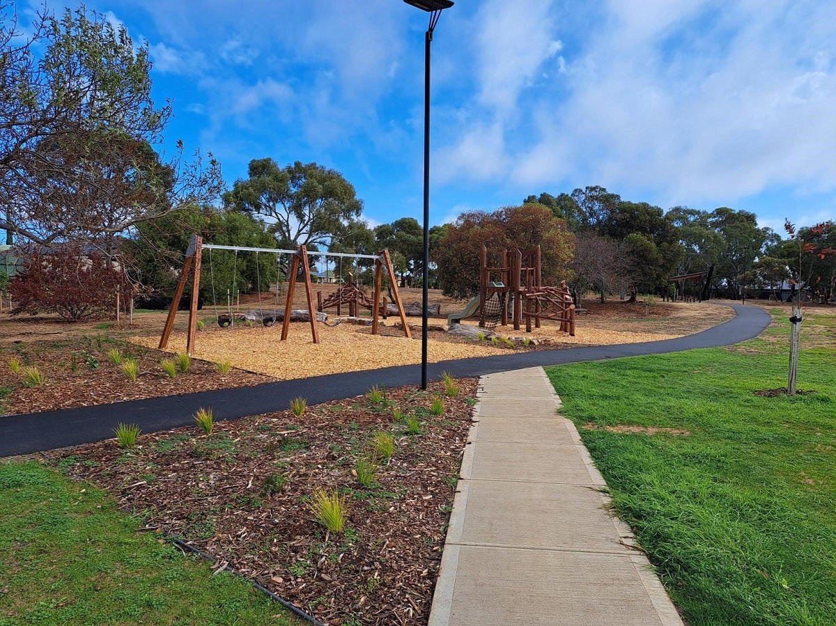 A view of the grass, play equipment and path at the upgraded Wakefield Reserve.