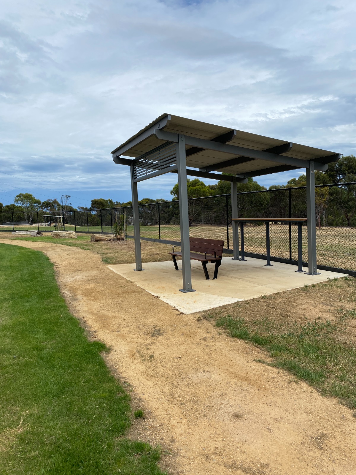 A shaded seating area at Woodcroft Dog Park.