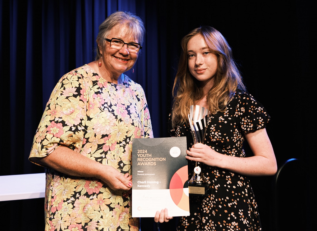 City of Onkaparinga Mayor Moira Were presents a certificate and trophy to Charli Haining Kennedy during the 2024 City of Onkaparinga Youth Recognition Awards ceremony.