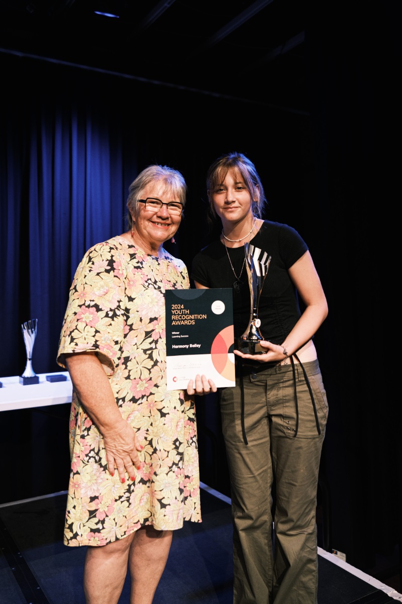 City of Onkaparinga Mayor Moira Were presents a certificate and trophy to Harmony Bailey during the 2024 City of Onkaparinga Youth Recognition Awards ceremony.