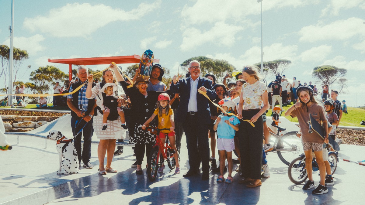 A crowd of skateboarders and bike riders celebrate with the Onkaparinga mayor, councillors and state government representatives following the ribbon cutting at Aldinga skate park.