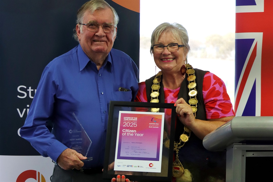 A photo of City of Onkaparinga Citizen of the Year Kerry McKeen holding his framed award alongside Mayor Moira Were.