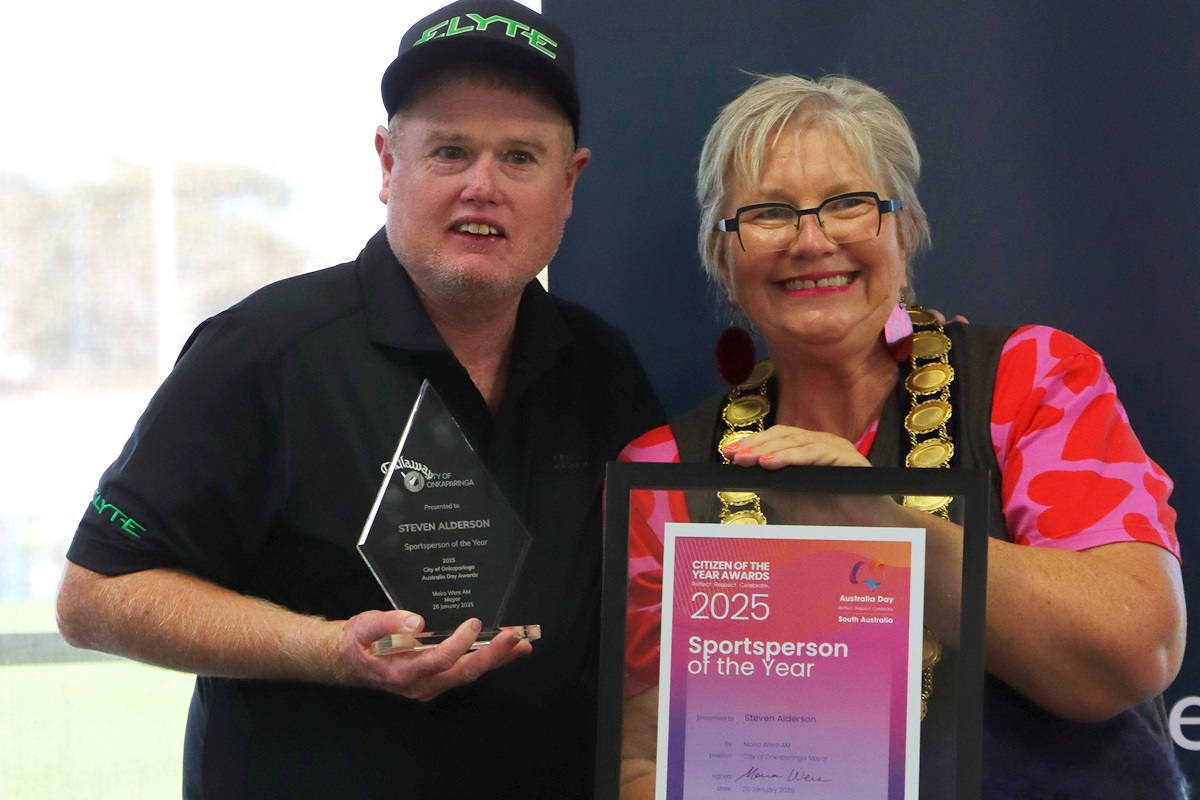 A photo of City of Onkaparinga Sportsperson of the Year Steven Alderson holding his framed award alongside Mayor Moira Were.