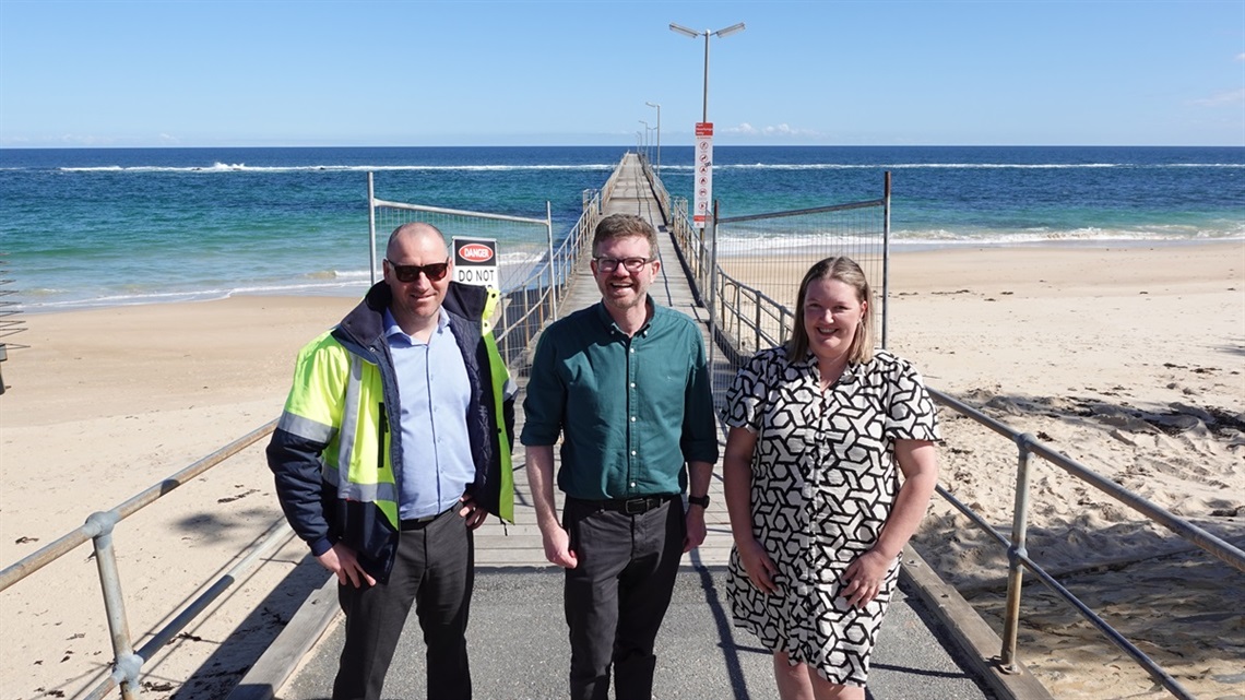 Council manager Matt Buckell, Chris Picton MP and Acting Mayor Lauren Jew stand in front of the Port Noarlunga jetty thatt has been reopened.