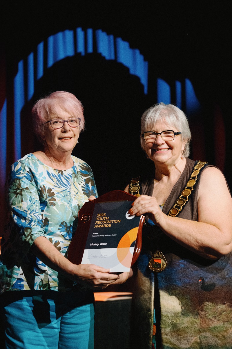 Ann, the grandmother of Neporendi Deadly Achiever Award winner Marley Ware, accepts Marley's award in her absence from Onkaparinga Mayor Moira Were.
