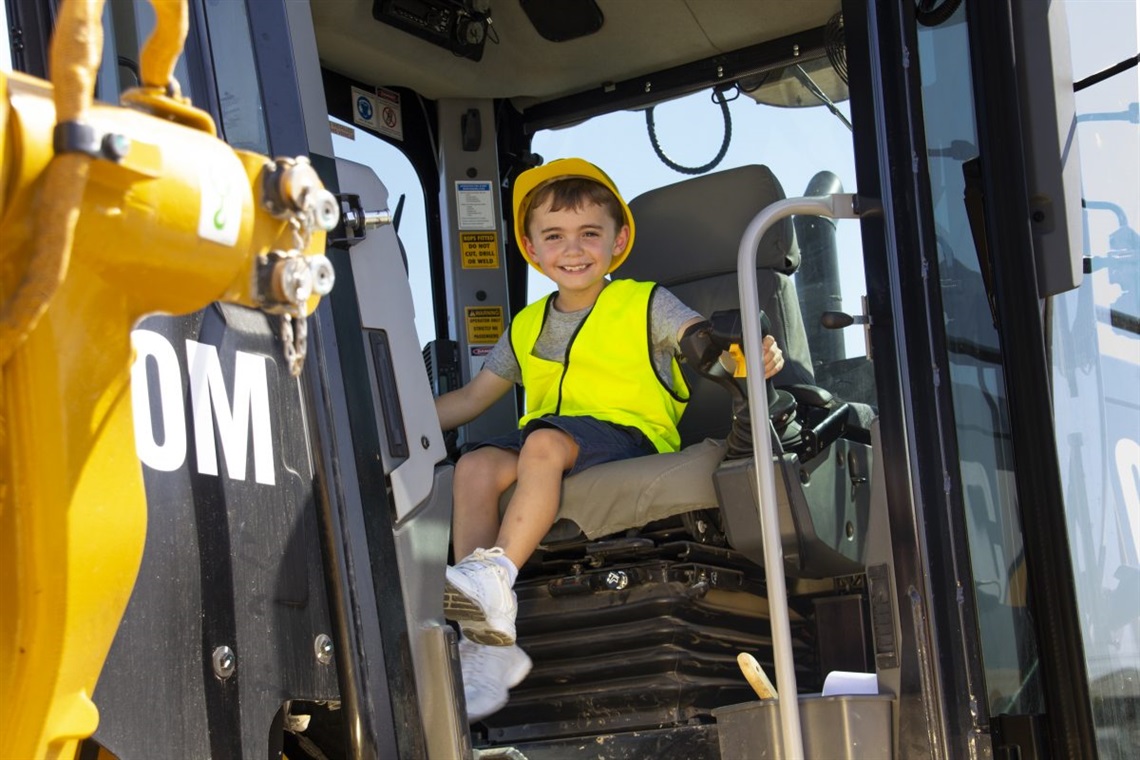 Aiden Bridgman with hard hat sitting in CAT truck