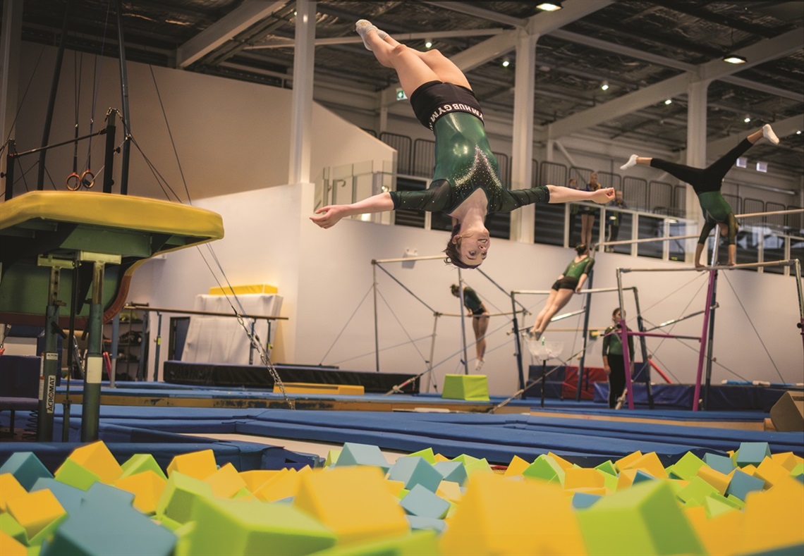 Hub Gymnastics - gymnast flipping into the foam pit