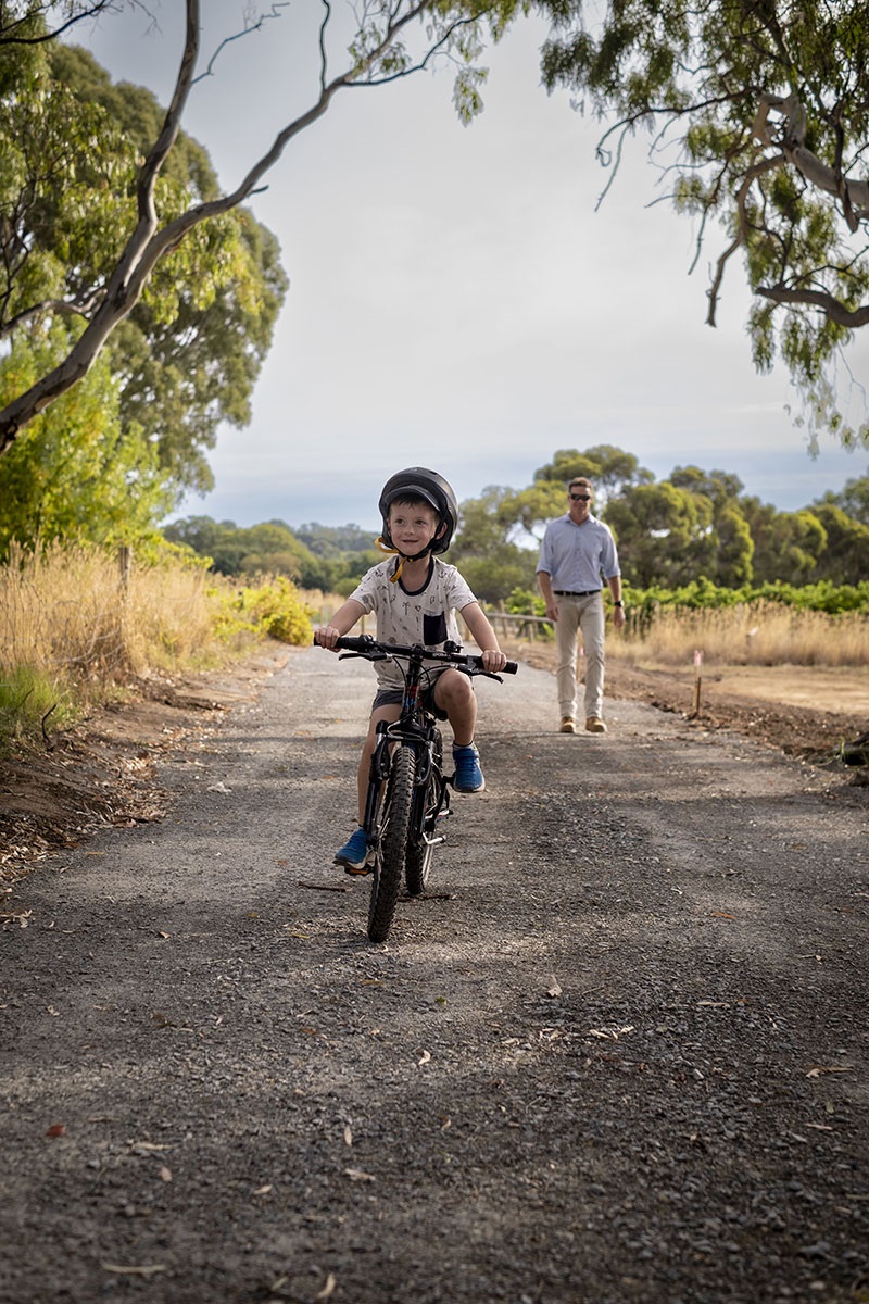 Boy rides bike on trail