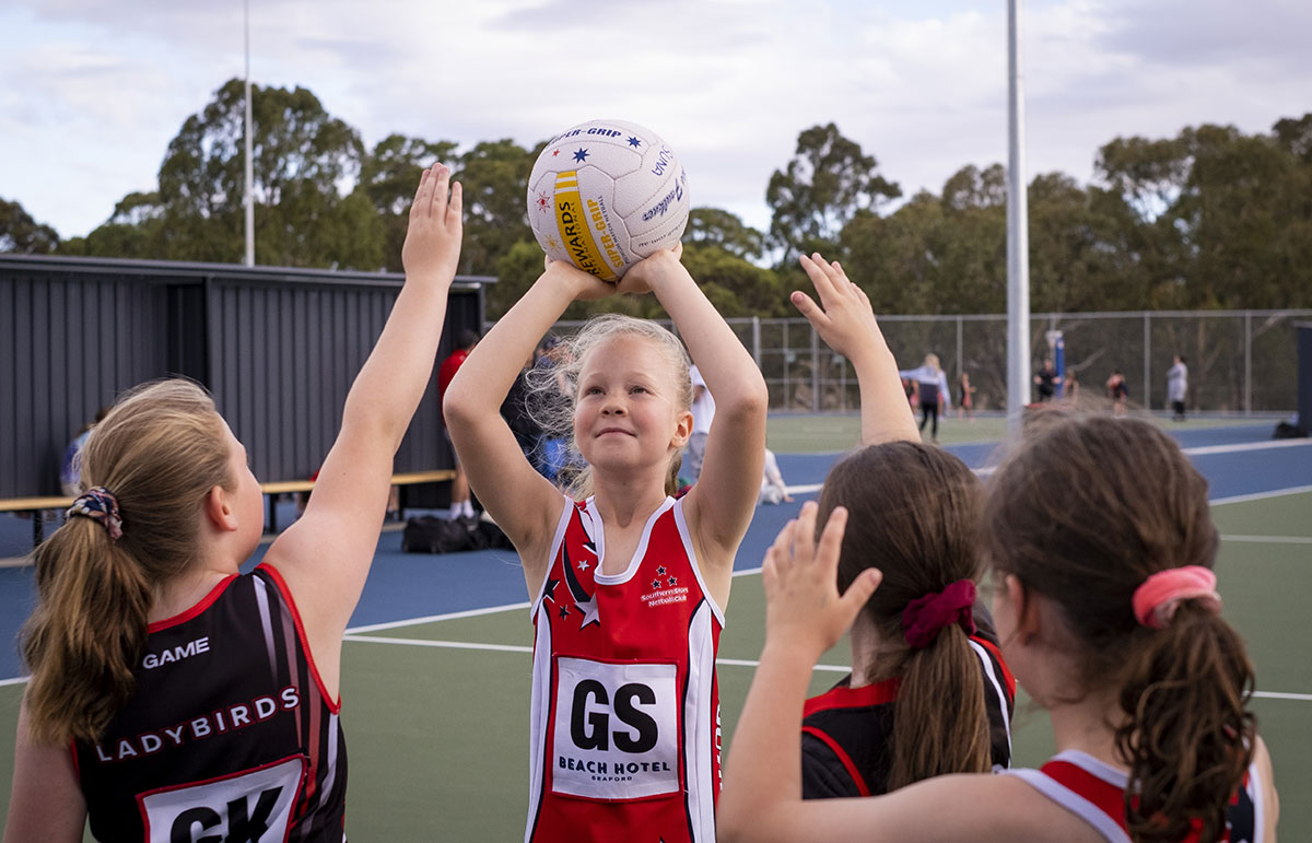 Young people playing netball